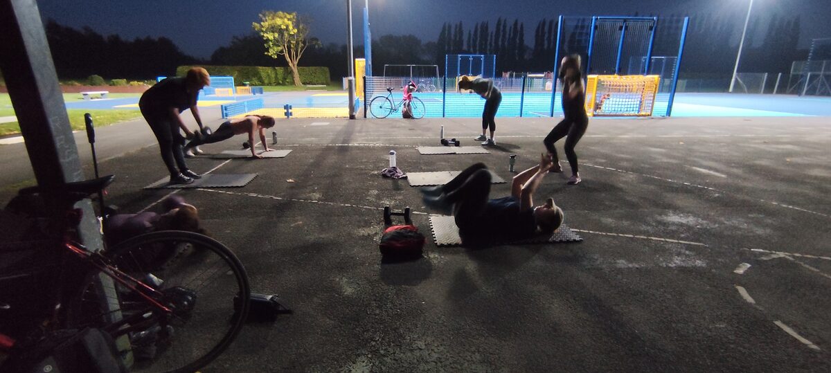 LGPT group training outdoors after dark in Ladybarn Park